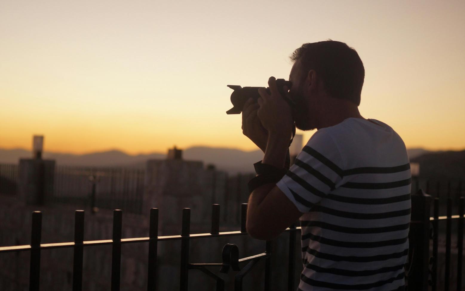 Street photographer at work in an urban environment